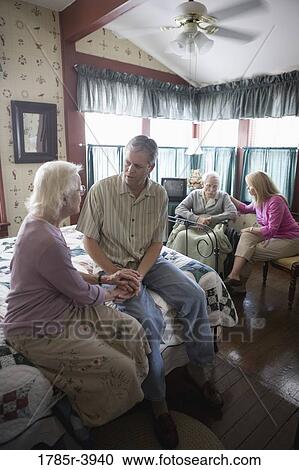 Adult children visiting and comforting senior parents in bedroom View Large Photo Image Stock Image - Adult children visiting and comforting senior parents in bedroom. Fotosearch