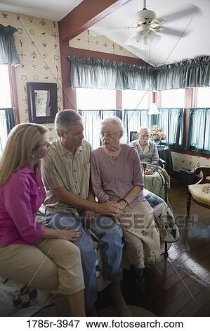 Adult children visiting and comforting senior parents in bedroom View Large Photo Image Stock Photo - Adult children visiting and comforting senior parents in bedroom. Fotosearch
