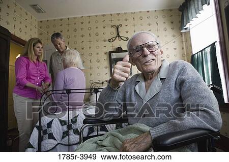 Adult children visiting and comforting senior parents in bedroom View Large Photo Image Stock Photo - Adult children visiting and comforting senior parents in bedroom. Fotosearch
