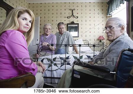 Adult children visiting and comforting senior parents in bedroom View Large Photo Image Stock Photograph - Adult children visiting and comforting senior parents in bedroom. Fotosearch