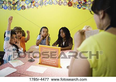 An art teacher demonstrating an art project to her young students in art class View Large Photo Image Stock Photo - An art teacher demonstrating an art project to her young students in art class. Fotosearch