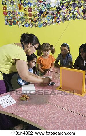An art teacher observing her students drawing in art class View Large Photo Image Stock Image - An art teacher observing her students drawing in art class. Fotosearch