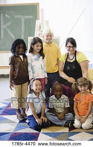 An art teacher posing with her students in classroom View Large Photo Image Stock Image - An art teacher posing with her students in classroom. Fotosearch