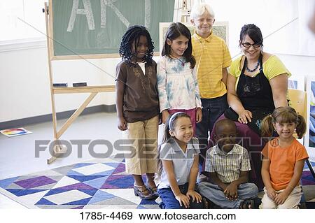 An art teacher posing with her students in classroom View Large Photo Image Stock Photo - An art teacher posing with her students in classroom. Fotosearch