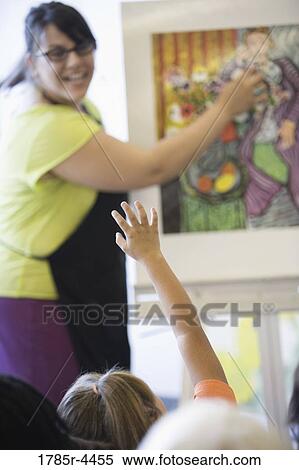 An art teacher showing painting to young students in art class View Large Photo Image Stock Photography - An art teacher showing painting to young students in art class. Fotosearch