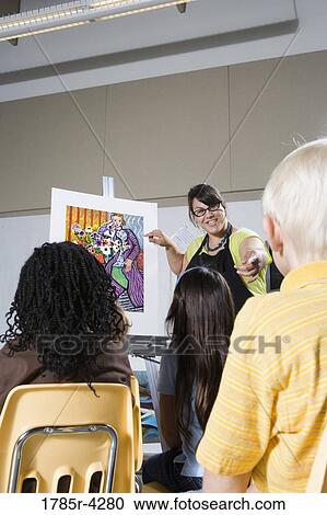 An art teacher standing by easel teaching her young students in art class View Large Photo Image Stock Image - An art teacher standing by easel teaching her young students in art class. Fotosearch