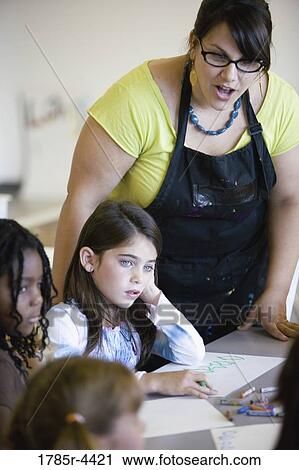 An art teacher with her young students in art class View Large Photo Image Stock Image - An art teacher with her young students in art class. Fotosearch