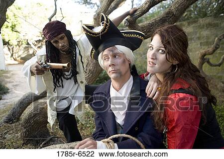 Armed pirates holding a navy officer as hostage and threatening him with weapons View Large Photo Image Stock Image - Armed pirates holding a navy officer as hostage and threatening him with weapons. Fotosearch