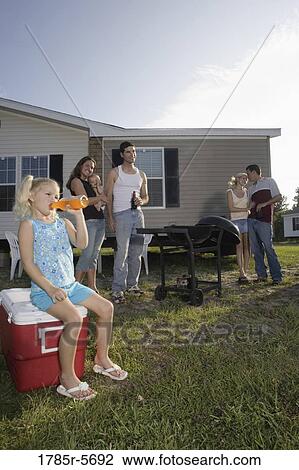 Blue collar families enjoying a cookout in front of trailer home View Large Photo Image Stock Image - Blue collar families enjoying a cookout in front of trailer home. Fotosearch