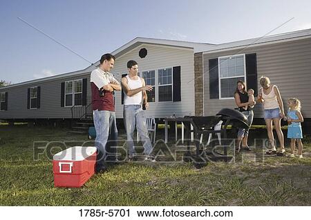 Blue collar families enjoying a cookout in front of trailer home View Large Photo Image Stock Image - Blue collar families enjoying a cookout in front of trailer home. Fotosearch