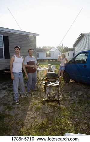 Blue collar families enjoying a cookout in front of trailer home View Large Photo Image Stock Image - Blue collar families enjoying a cookout in front of trailer home. Fotosearch