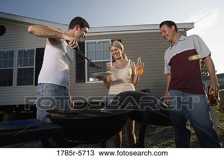 Blue collar families enjoying a cookout in front of trailer home View Large Photo Image Stock Image - Blue collar families enjoying a cookout in front of trailer home. Fotosearch