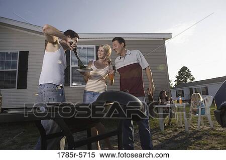 Blue collar families enjoying a cookout in front of trailer home View Large Photo Image Stock Photography - Blue collar families enjoying a cookout in front of trailer home. Fotosearch