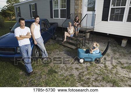Blue-collar families in front of a trailer home View Large Photo Image Stock Image - Blue-collar families in front of a trailer home. Fotosearch