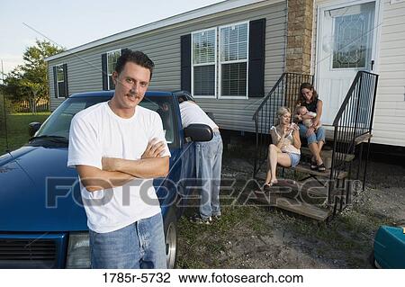 Blue-collar families relaxing in front of a trailer home View Large Photo Image Stock Image - Blue-collar families relaxing in front of a trailer home. Fotosearch