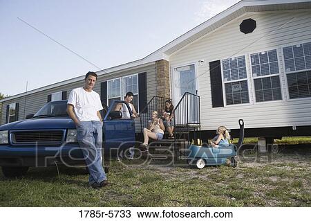 Blue-collar families relaxing in front of a trailer home View Large Photo Image Stock Image - Blue-collar families relaxing in front of a trailer home. Fotosearch