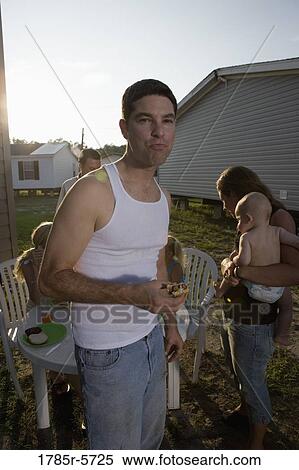 Blue-collar man eating a burger View Large Photo Image Stock Photography - Blue-collar man eating a burger. Fotosearch