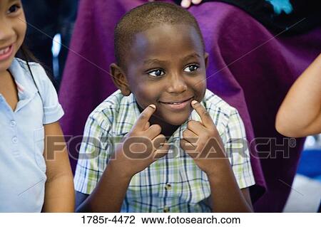 Boy (5-6) smiling with friends View Large Photo Image Stock Image - Boy (5-6) smiling with friends. Fotosearch