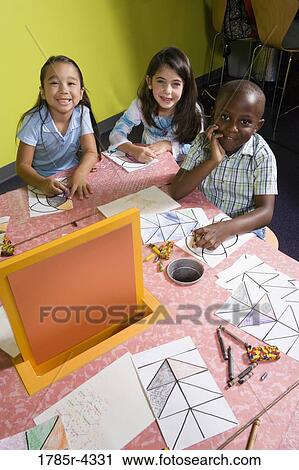 Boy and girls drawing in an art class View Large Photo Image Stock Image - Boy and girls drawing in an art class. Fotosearch