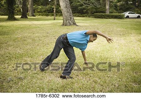 Boy doing cartwheel on the grass View Large Photo Image Stock Image - Boy doing cartwheel on the grass. Fotosearch