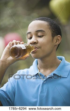 Boy drinking bottle of soda View Large Photo Image Picture - Boy drinking bottle of soda. Fotosearch