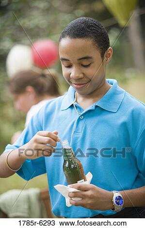 Boy holding a drink bottle View Large Photo Image Stock Image - Boy holding a drink bottle. Fotosearch