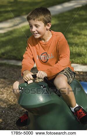 Boy playing at a playground View Large Photo Image Stock Image - Boy playing at a playground. Fotosearch