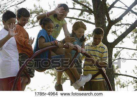 Boys and girls climbing on monkey bars at a playground View Large Photo Image Picture - Boys and girls climbing on monkey bars at a playground. Fotosearch