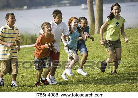 Boys and girls running side by side at a park View Large Photo Image Stock Photo - Boys and girls running side by side at a park. Fotosearch