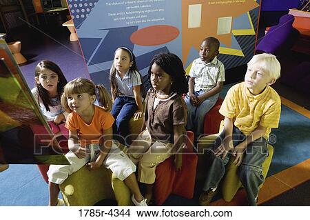 Boys and girls watching and listening attentively in a class View Large Photo Image Picture - Boys and girls watching and listening attentively in a class. Fotosearch