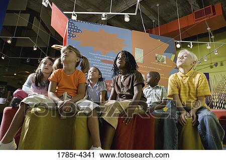 Boys and girls watching and listening attentively in a class View Large Photo Image Stock Image - Boys and girls watching and listening attentively in a class. Fotosearch