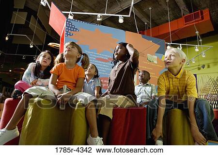 Boys and girls watching and listening attentively in a class View Large Photo Image Stock Image - Boys and girls watching and listening attentively in a class. Fotosearch