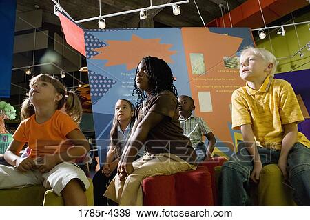 Boys and girls watching and listening attentively in a class View Large Photo Image Stock Photo - Boys and girls watching and listening attentively in a class. Fotosearch