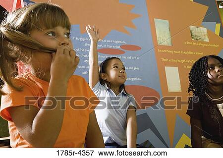 Boys and girls watching and listening attentively in an art class View Large Photo Image Stock Photo - Boys and girls watching and listening attentively in an art class. Fotosearch
