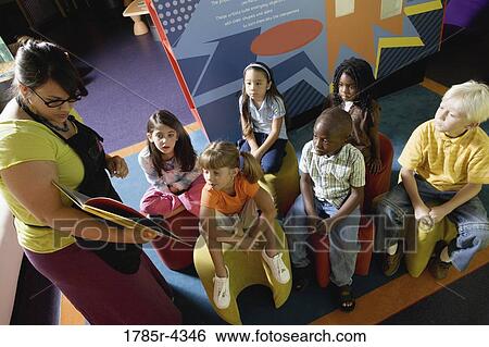 Boys and girls watching and listening attentively to their teacher View Large Photo Image Stock Photograph - Boys and girls watching and listening attentively to their teacher. Fotosearch