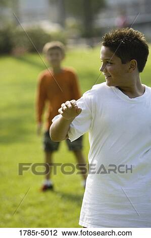 Boys playing at a park View Large Photo Image Stock Image - Boys playing at a park. Fotosearch