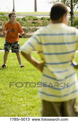 Boys playing at a park View Large Photo Image Stock Image - Boys playing at a park. Fotosearch