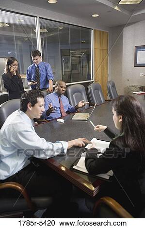 Business colleagues at a working meeting in a conference room View Large Photo Image Stock Image - Business colleagues at a working meeting in a conference room. Fotosearch