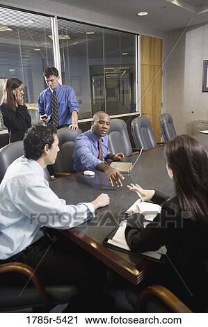 Business colleagues at a working meeting in a conference room View Large Photo Image Stock Image - Business colleagues at a working meeting in a conference room. Fotosearch