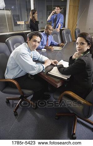 Stock Image - Business colleagues at a working meeting in a conference room. Fotosearch