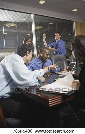 Business colleagues at a working meeting in a conference room View Large Photo Image Stock Image - Business colleagues at a working meeting in a conference room. Fotosearch
