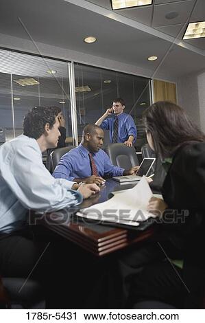 Stock Image - Business colleagues at a working meeting in a conference room. Fotosearch