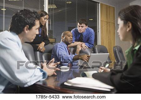 Business colleagues at a working meeting in a conference room View Large Photo Image Stock Image - Business colleagues at a working meeting in a conference room. Fotosearch