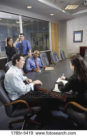 Business colleagues at a working meeting in a conference room View Large Photo Image Stock Photo - Business colleagues at a working meeting in a conference room. Fotosearch