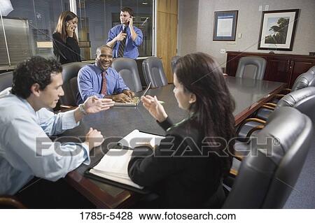 Business colleagues at a working meeting in a conference room View Large Photo Image Stock Photo - Business colleagues at a working meeting in a conference room. Fotosearch