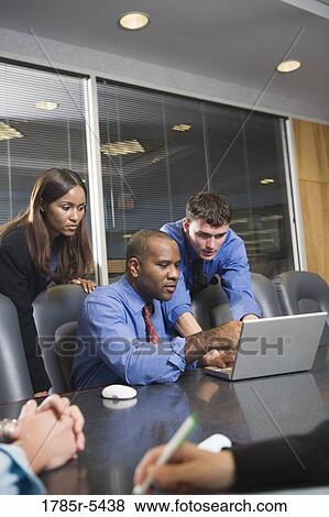 Stock Photo - Business colleagues at a working meeting in a conference room. Fotosearch