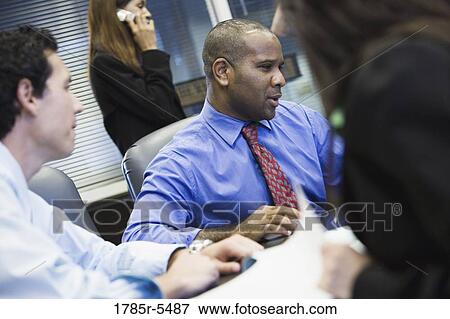 Business colleagues at a working meeting in a conference room View Large Photo Image Stock Photo - Business colleagues at a working meeting in a conference room. Fotosearch