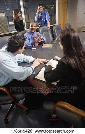 Business colleagues at a working meeting in a conference room View Large Photo Image Stock Photograph - Business colleagues at a working meeting in a conference room. Fotosearch