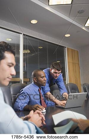 Business colleagues at a working meeting in a conference room View Large Photo Image Stock Photograph - Business colleagues at a working meeting in a conference room. Fotosearch