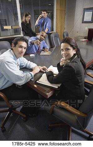 Business colleagues at a working meeting in a conference room View Large Photo Image Stock Photography - Business colleagues at a working meeting in a conference room. Fotosearch
